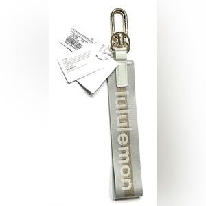 Lululemon Never Lost Keychain Wordmark Vapor Gold, NEW
